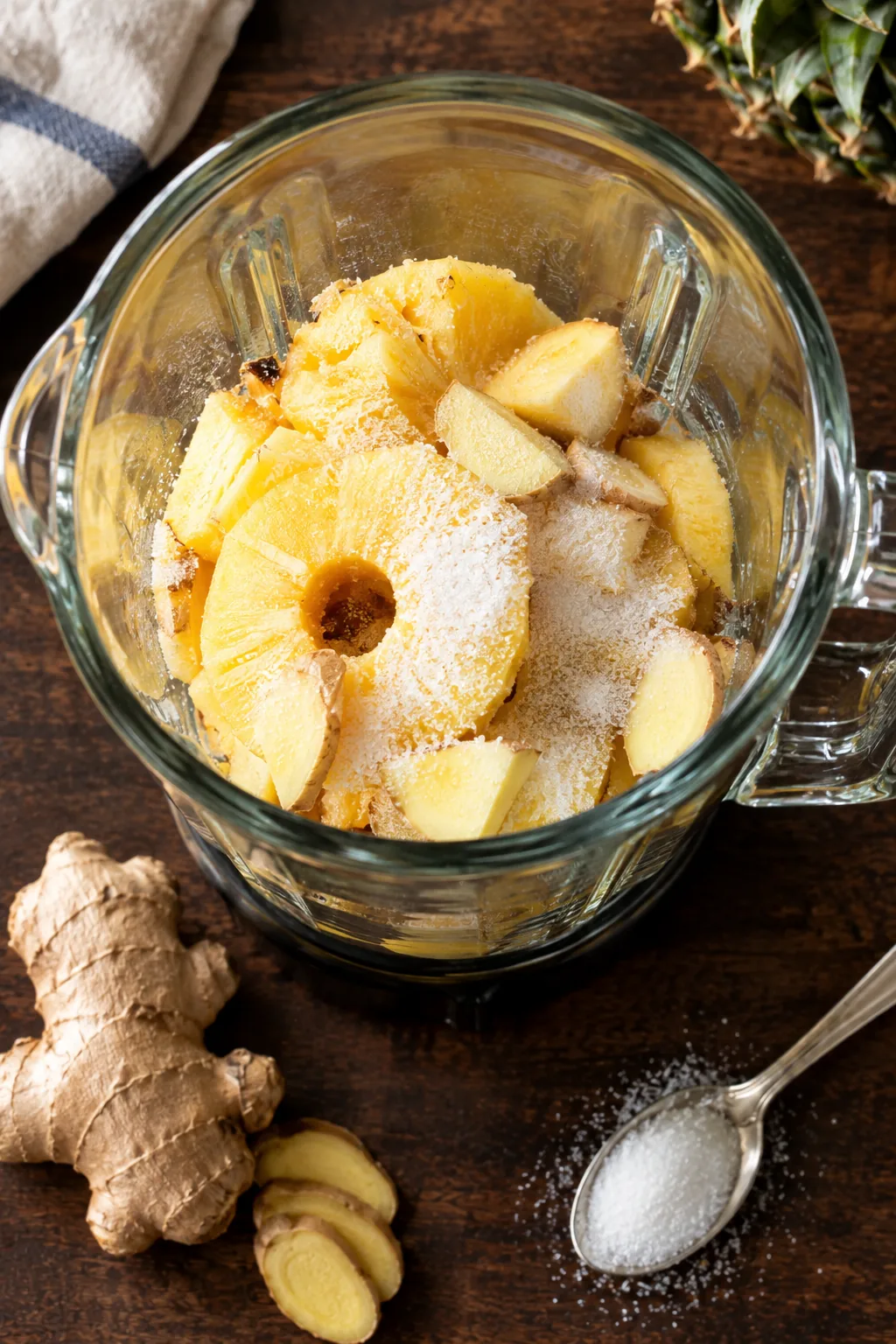 Pineapple rings, roughly cut fresh ginger and sugar loaded into the blender